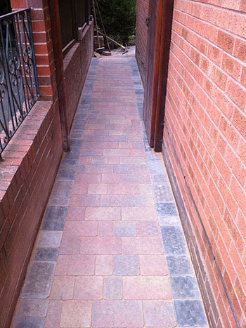 The block paving was continued around the house to create a matching pathway