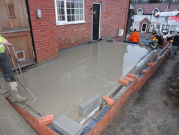 The concrete is added to the base